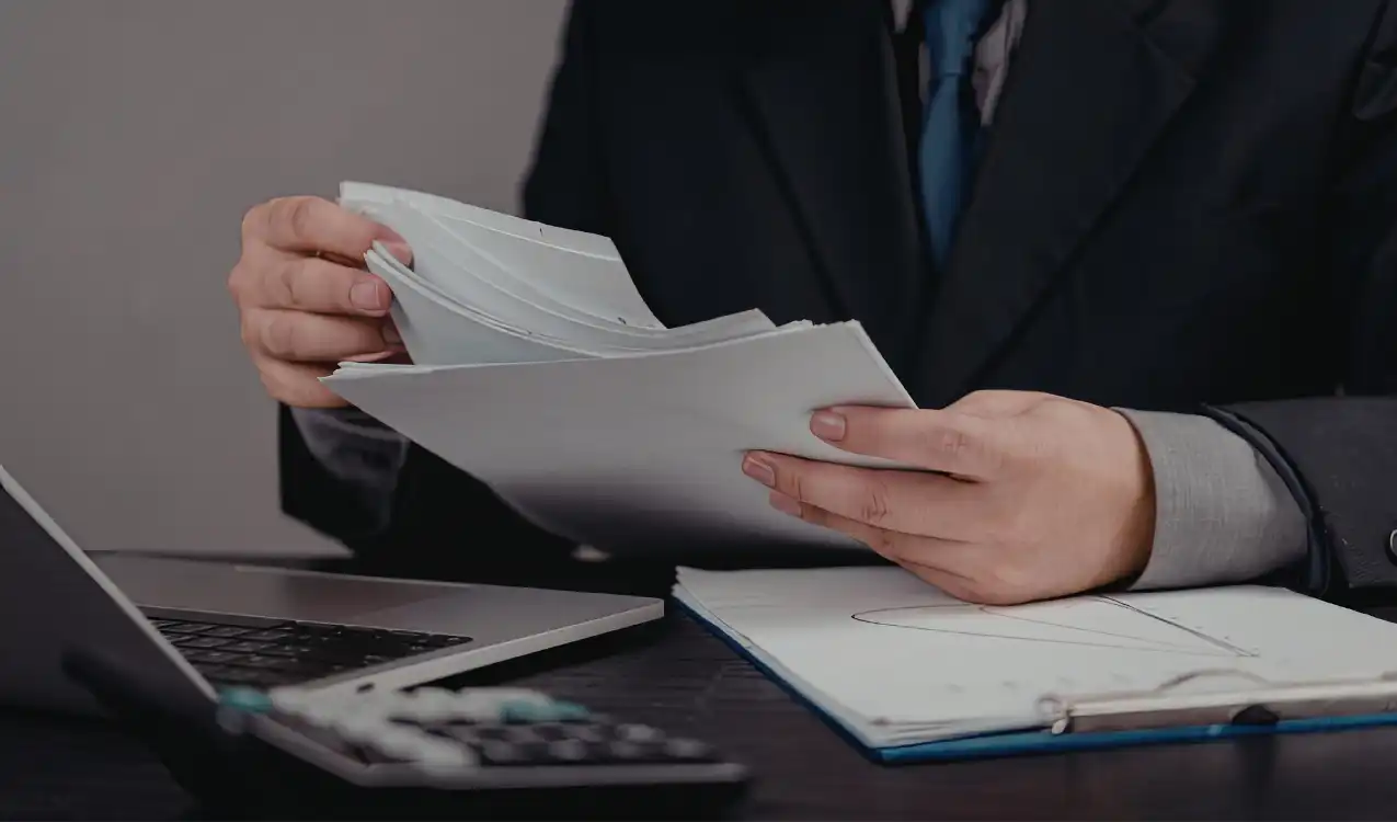 Professional solicitor conducting auction property ID checks in a modern office.