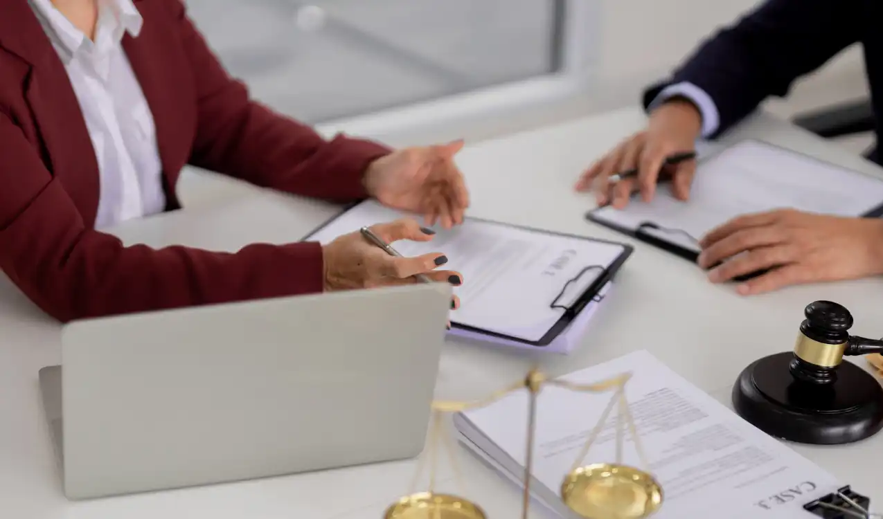 Auction conveyancing solicitor reviewing legal pack and completion deadline documents for property buyer