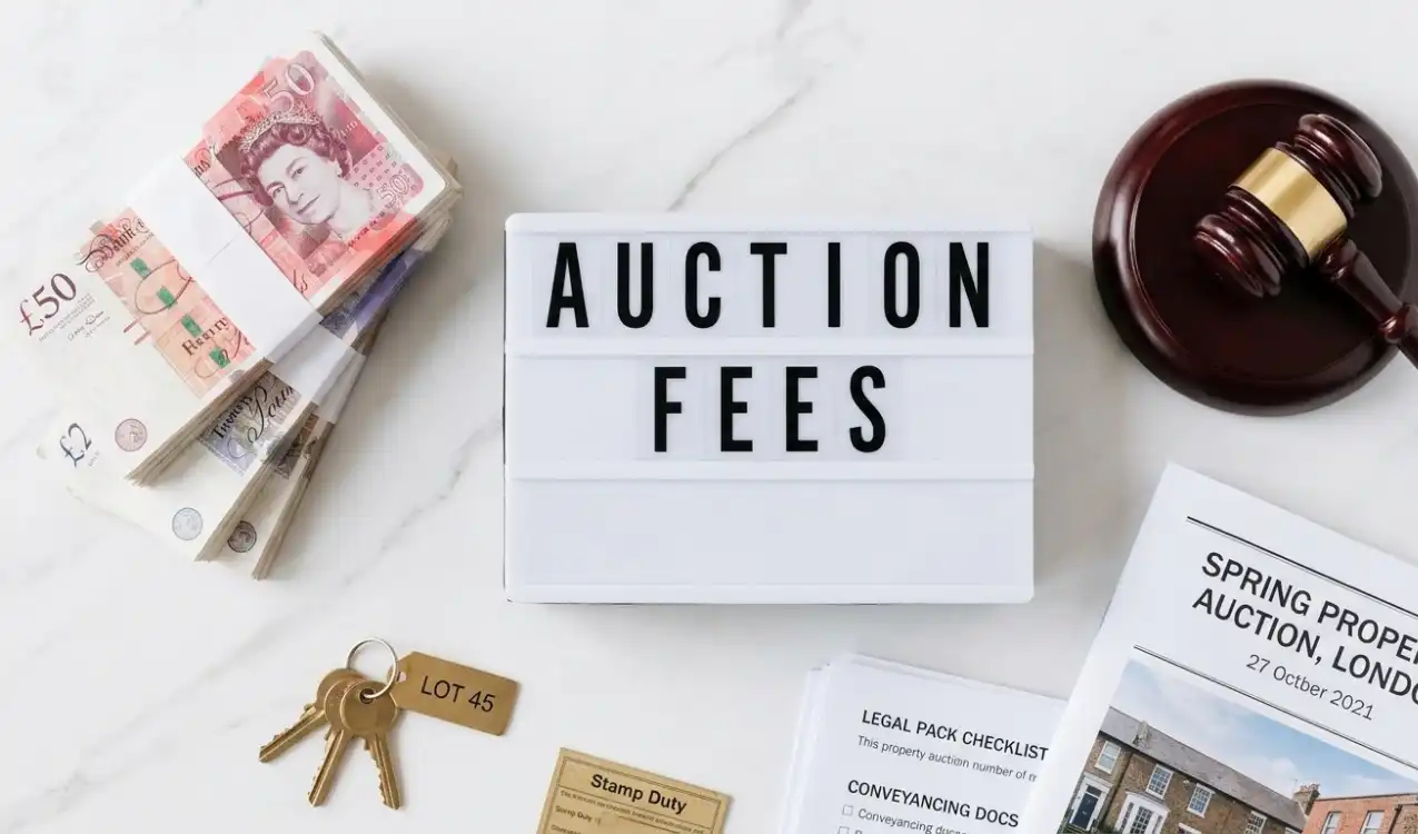 Buyer reviewing property auction fees and costs at a UK property auction — full fee breakdown guide