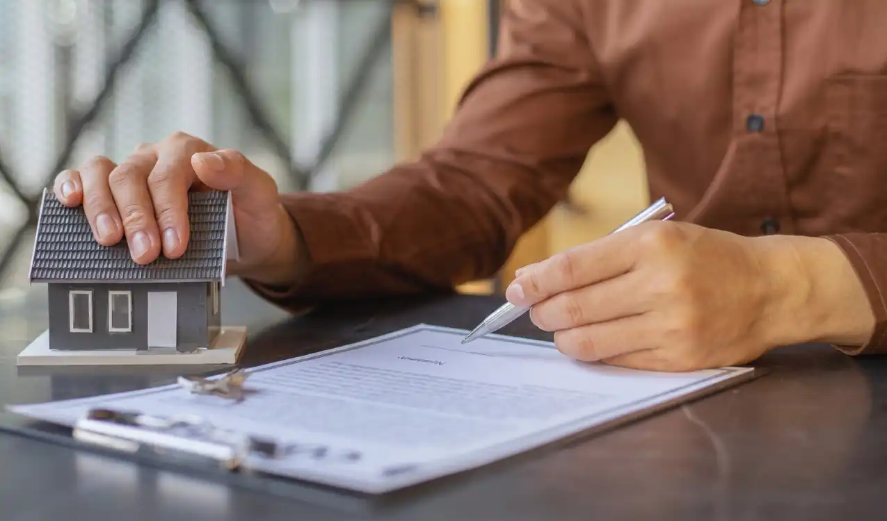 Modern method of auction reservation fee — UK buyer signing reservation agreement at conditional auction with solicitor reviewing 56-day completion timeline