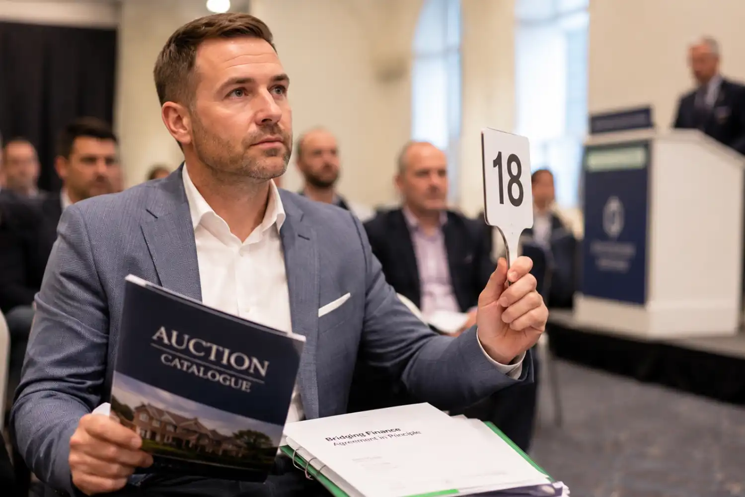 Using a bridging loan to buy at auction — property investor at UK auction with finance in place